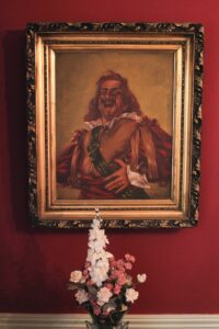 Classical portrait painting — figure in red robes with ornate frame