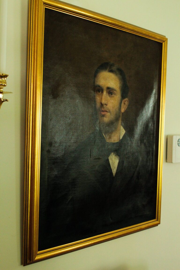 Classical portrait painting — young man in formal attire with gold frame