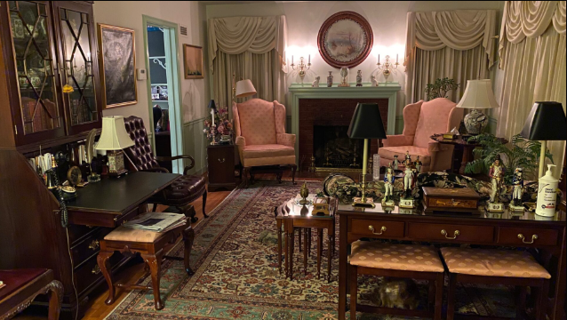 Guest living room with Chippendale secretary desk and camel-back sofa